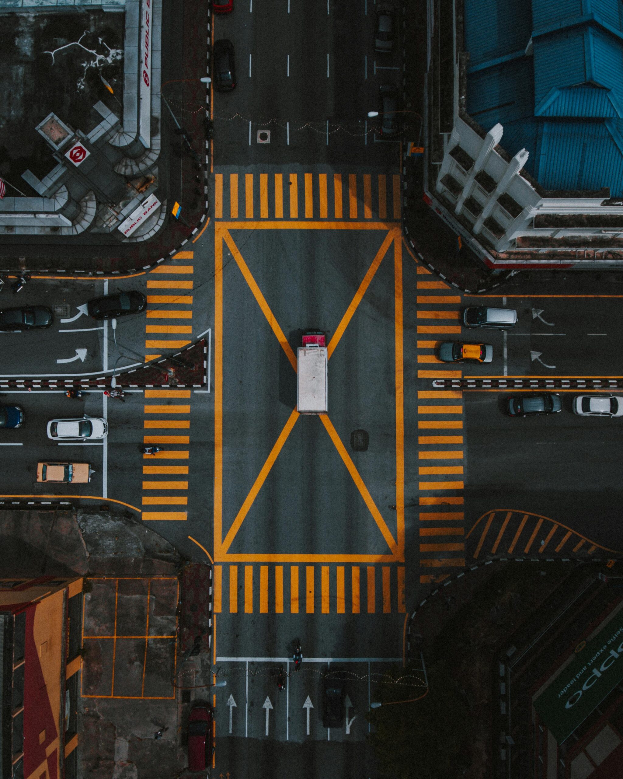 High-angle aerial view of a busy intersection in Ipoh, Malaysia, showcasing urban road layout.